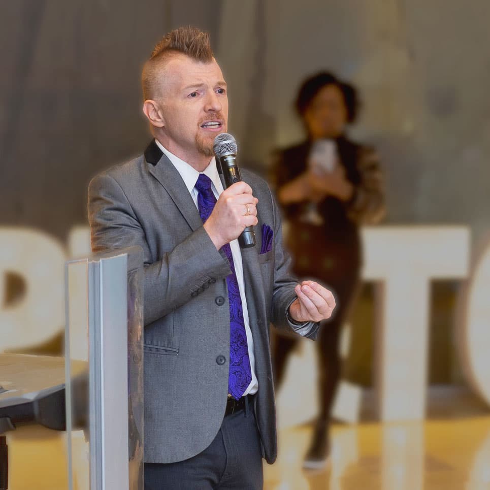 Shane Lukas speaking at a 2025 event